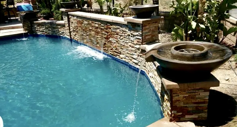 Sheer descent and a fire-and-water bowl on a stacked-stone wall