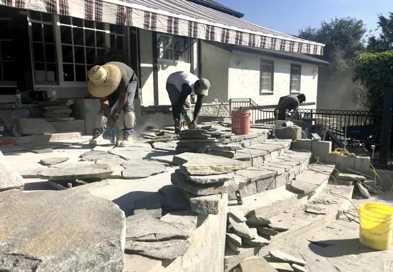 DPC crew hand-setting flagstone on the new pool steps
