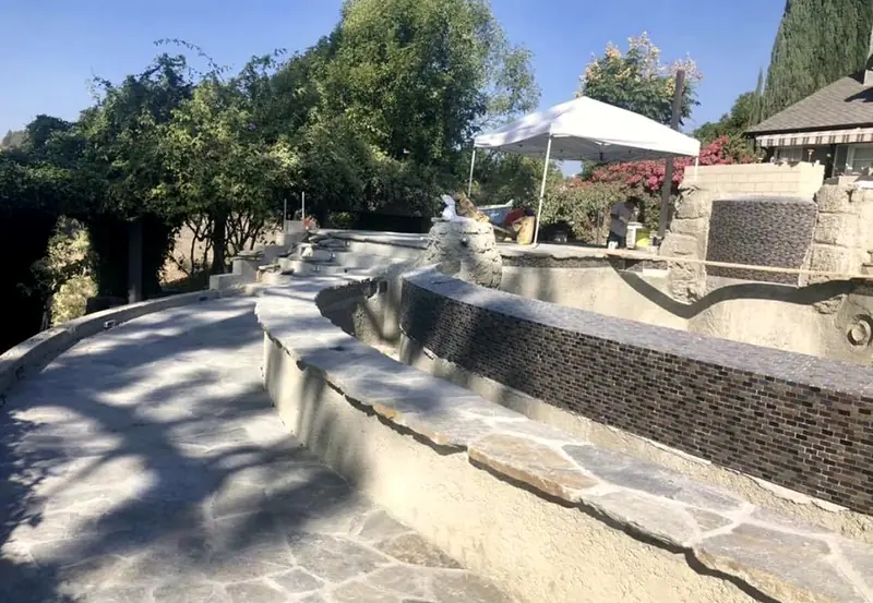 Glass tile going onto the raised spillway wall